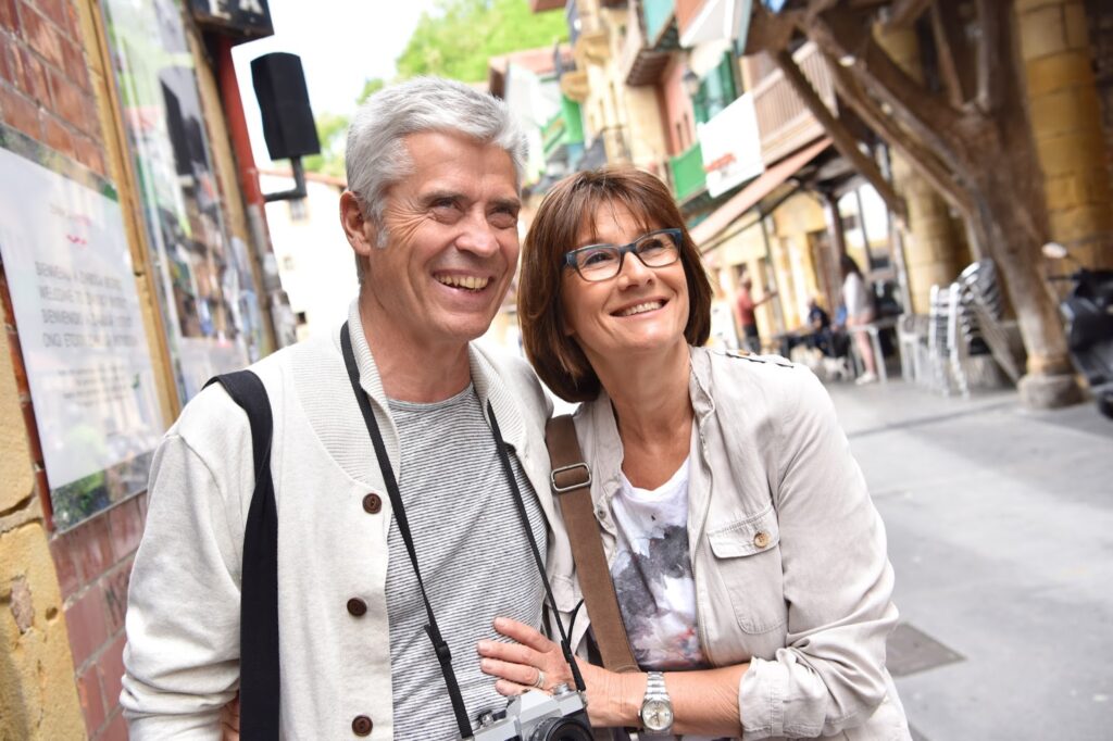 A couple standing on a street in a city while discussing the benefits of the MonaLisa Touch treatment for intimate wellness.