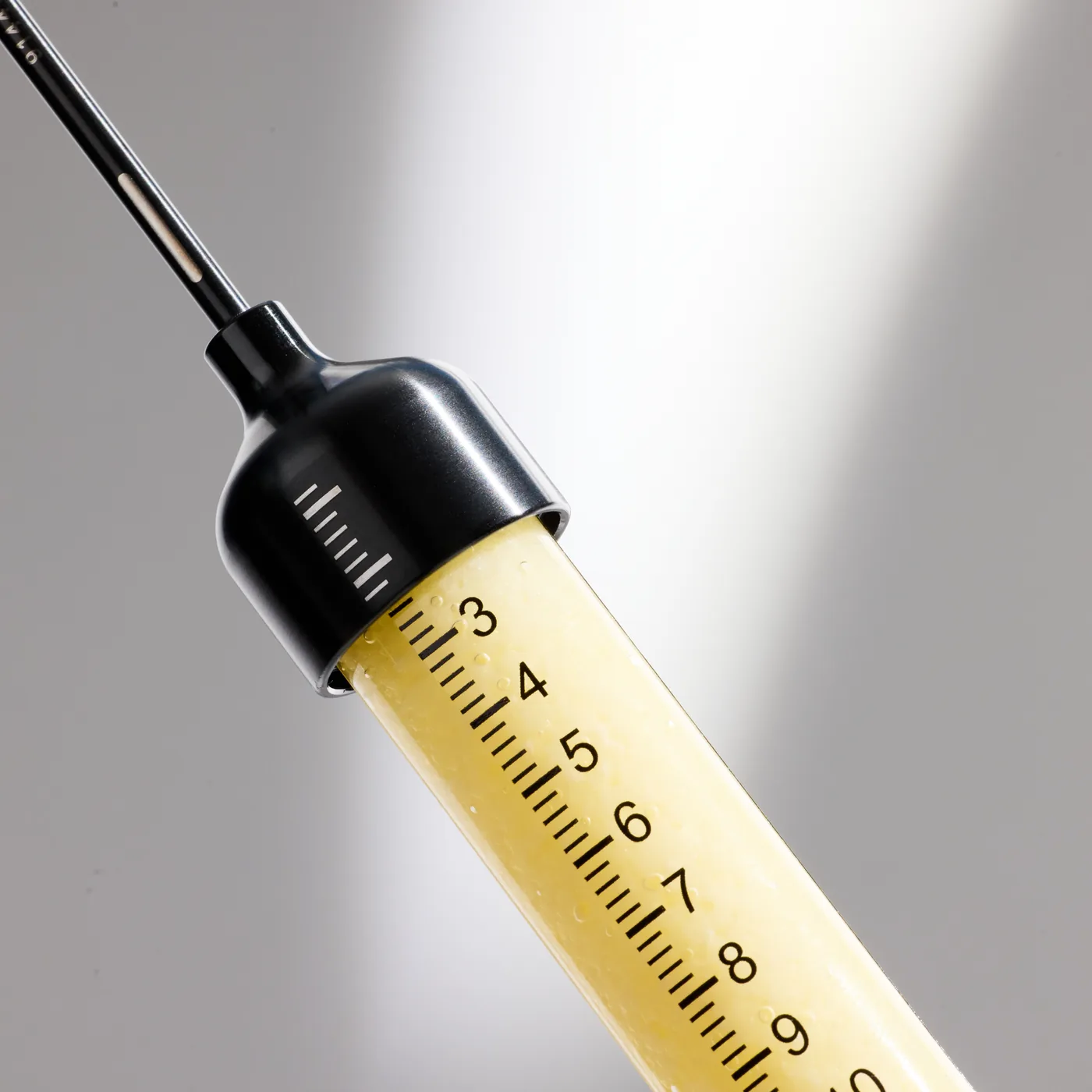 A prefilled alloClae syringe of processed donor adipose tissue, shown close up before injection
